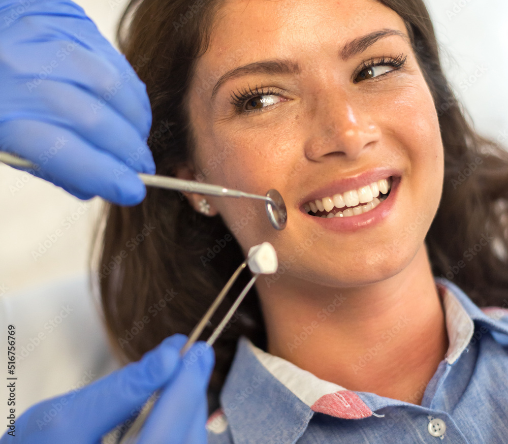Young woman checking her teeth at the dentist clinic Young woman checking her teeth at the dentist clinic