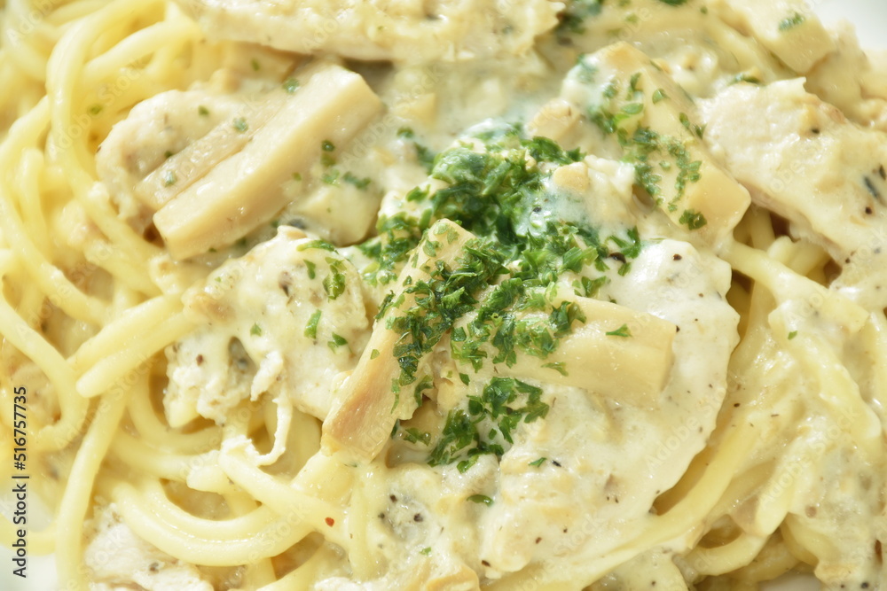 steamed spaghetti with white truffle mushroom cream sauce topping slice chicken breast on plate steamed spaghetti with white truffle mushroom cream sauce topping slice chicken breast on plate