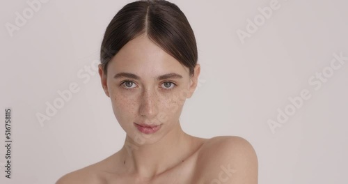 Beautiful young caucasian woman with clean fresh skin on white background