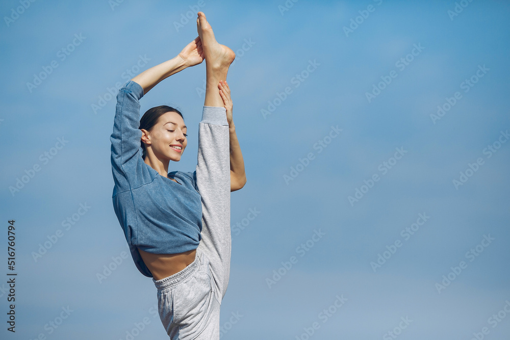 Cute girl training on a sky backgroung Cute girl training on a sky backgroung