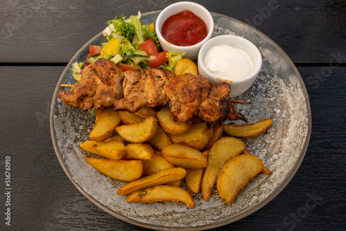 Grilled chicken with vegetarian salad and french fries