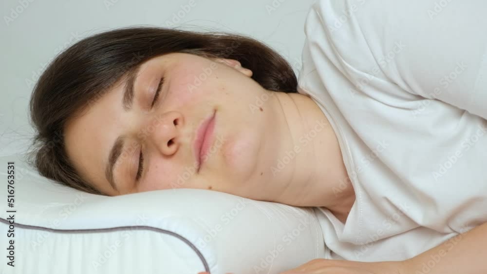 A woman goes to bed on an orthopedic pillow and mattress. Choosing the right place to sleep. A woman goes to bed on an orthopedic pillow and mattress. Choosing the right place to sleep.