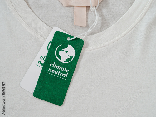 Carbon neutral t-shirt, Label Climate neutral on new clothes. Carbon neutral label concept in apparel, fashion industry. Ethical consumption.Increasing awareness for customers - carbon footpint photo