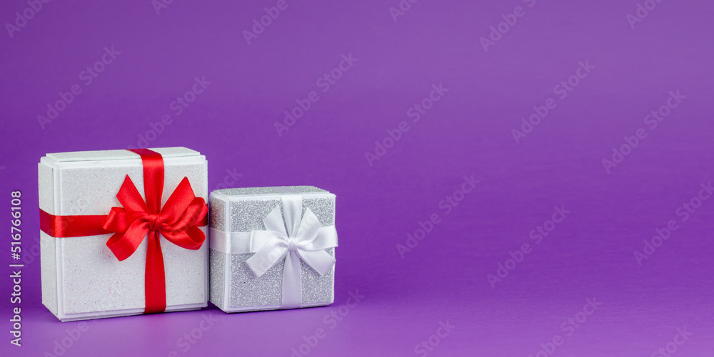 Big and small gift boxes on purple background Big and small gift boxes on purple background