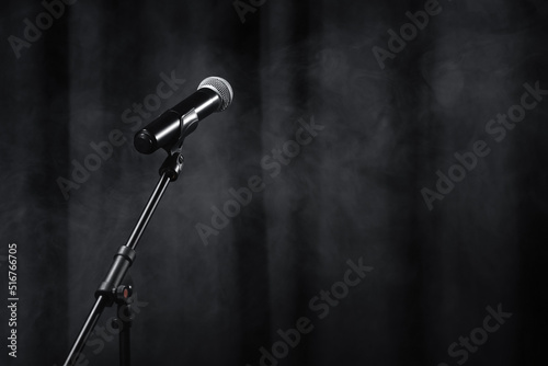 Obraz na plátne microphone on stand on black stage with curtain and smoke.