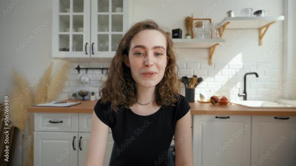 Woman talks to boyfriend on video call drinking tea. Young lady turns to mother to continue communication sitting at kitchen table from POV to third party Woman talks to boyfriend on video call drinking tea. Young lady turns to mother to continue communication sitting at kitchen table from POV to third party