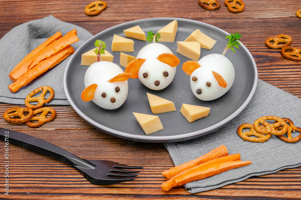 Small chicken eggs mouse,mice with ears of carrot,cheese on plate,creative, fun food,healthy lunch snack breakfast idea for kids party. Menu for spooky Halloween dessert treats, edible cute rat