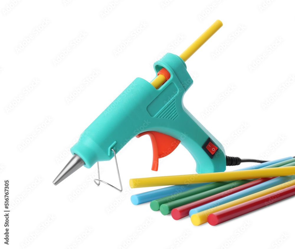 Turquoise glue gun and colorful sticks on white background Turquoise glue gun and colorful sticks on white background