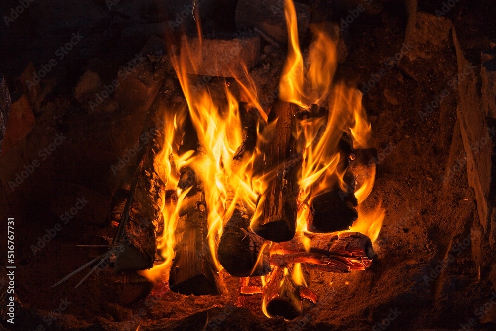Open log fire in fireplace.