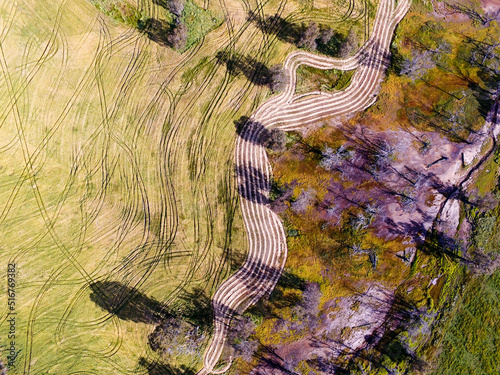 Aerial view over farmland with squiggly lines in crop photo