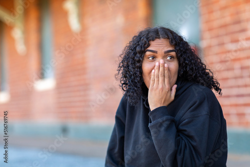 teenager being surprised with hand up to face