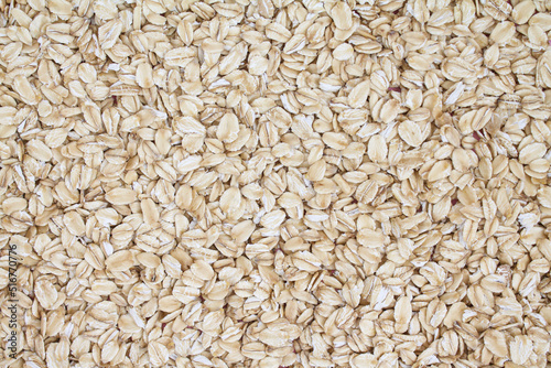 Close up top view rolled oats texture background, oat flakes, oatmeal