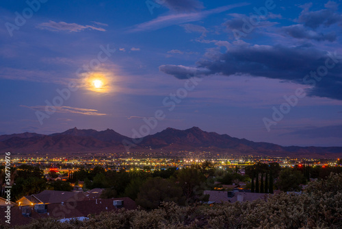 The moon rises over the city of Kingman, Arizona photo