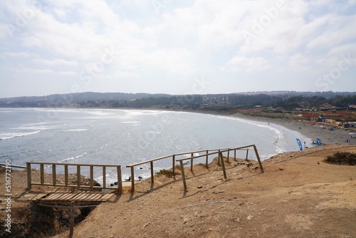 Surfing beach in Pichilemu, Chile, view from the cliff on morning (Punta de los lobos) photo