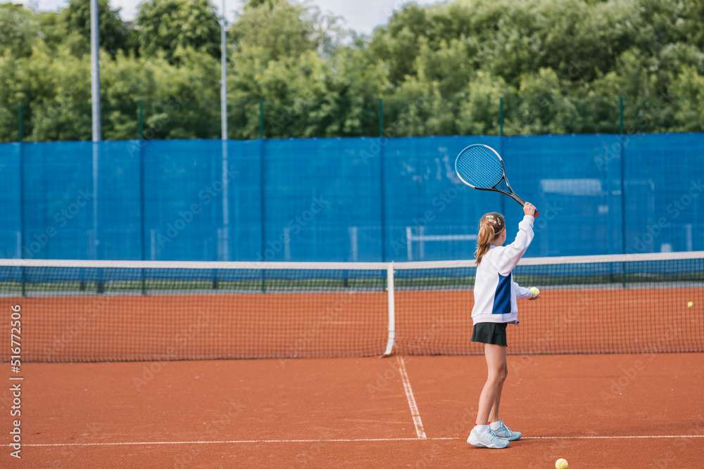 Girl playing tennis on court. Young professionals concept.