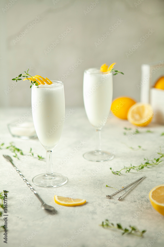 Two glasses of lemon sorbet on the table - obrazy, fototapety, plakaty 