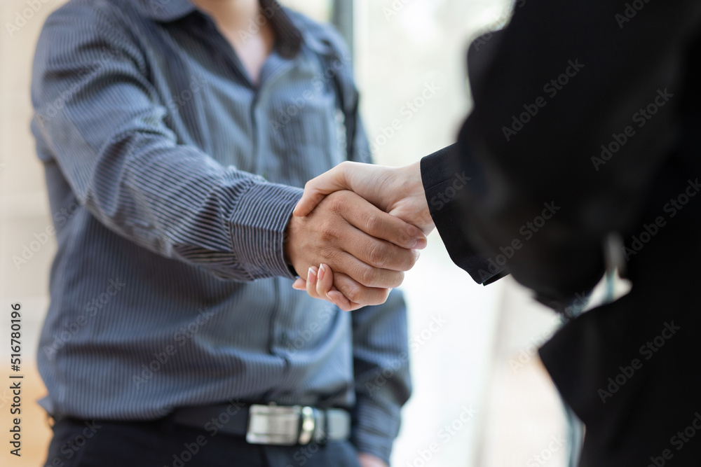 Handshake. Businessman shaking hands with coworker and agreeing business partnership.
