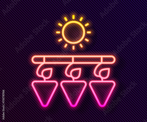 Glowing neon line Drying grapes icon isolated on black background. Dried grapes. Vector