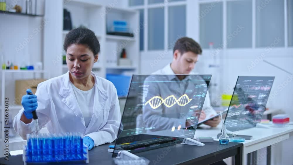 Lab technician dripping sample substance into flasks, dna sequence on screen