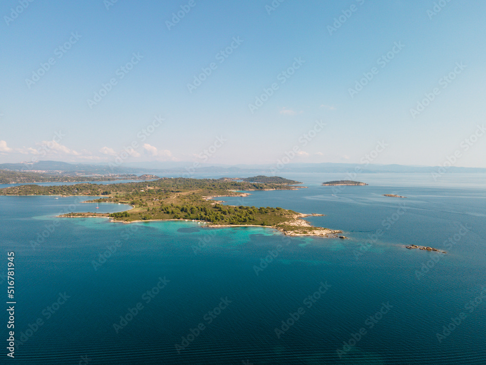 Aerial view of Diaporos Island in Halkidiki, Greece, Small islands with blue lagoon in the Aegean sea during summer holiday season