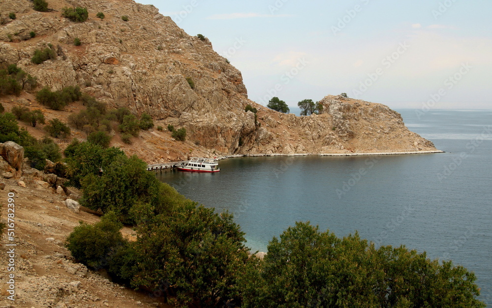 Landscape with mountains, boat and bay of Lake Van on Akdamar Island in Eastern Anatolia region, Turkey