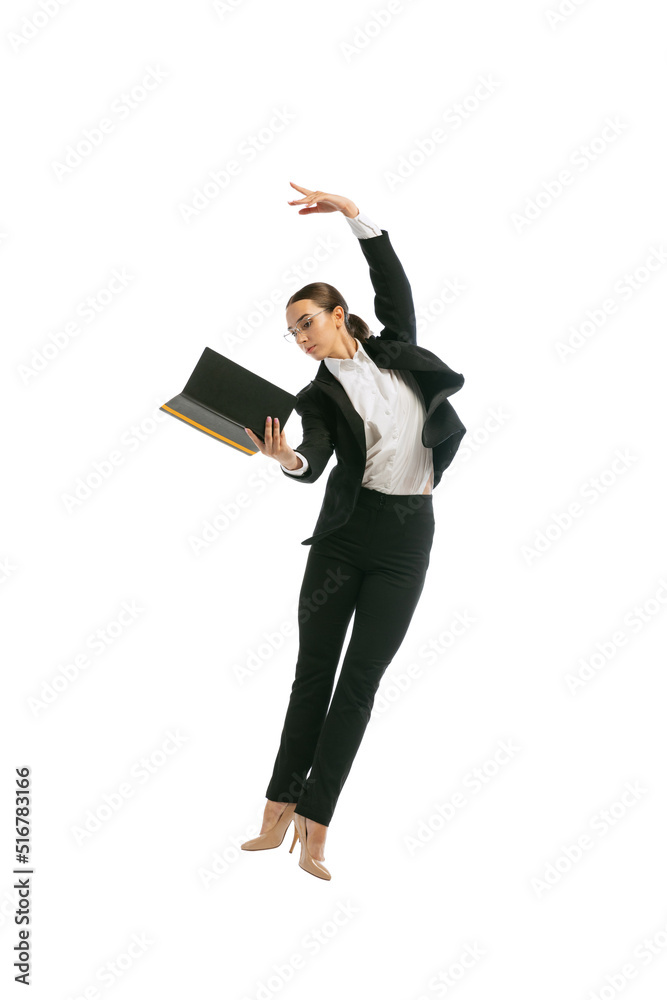 Beautiful young girl wearing business style outfit jumping and dancing isolated on white background. Business, start-up, open-space, professional occupation concept.
