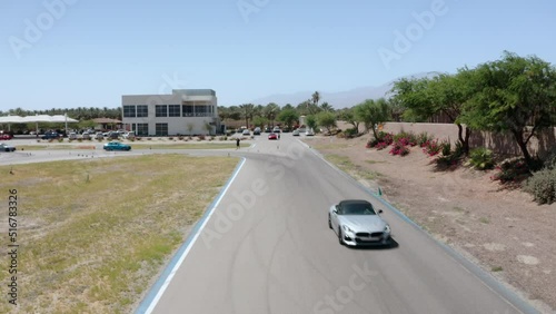 Drone captures an aerial shot of a car driving on a road in Palm Springs, California, near Los Angeles. photo