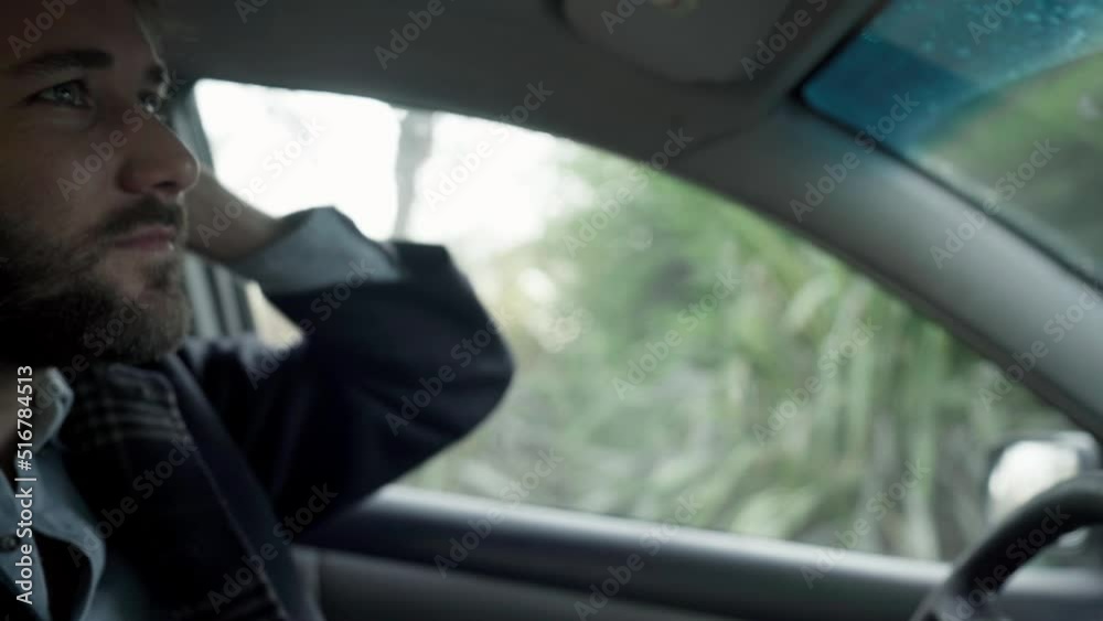 young hispanic man adjusts his hair while driving young hispanic man adjusts his hair while driving