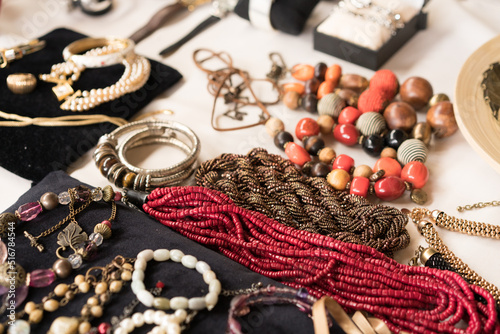Antiques at flea market or garage sale - vintage jewelry, retro beads necklace and other vintage things. Collectibles memorabilia concept. Selective focus