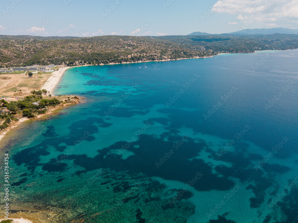 Aerial view of Agios Ioannis beach in Sithonia peninsula of Chalkidiki, Greece,  Tropical turquoise water during summer holiday season