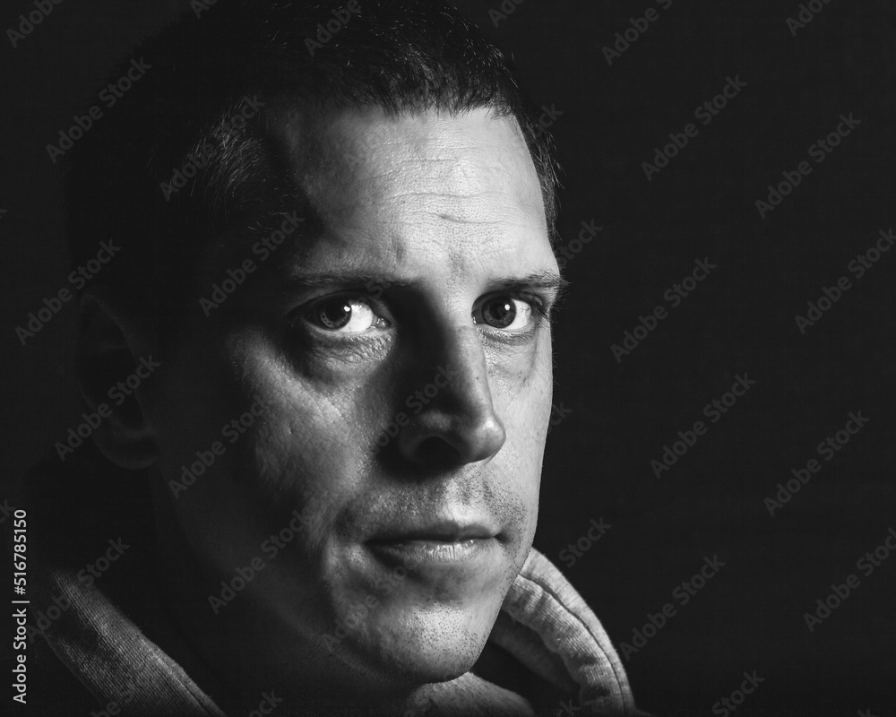 Fototapeta premium A reflective expression as a man looks into the camera