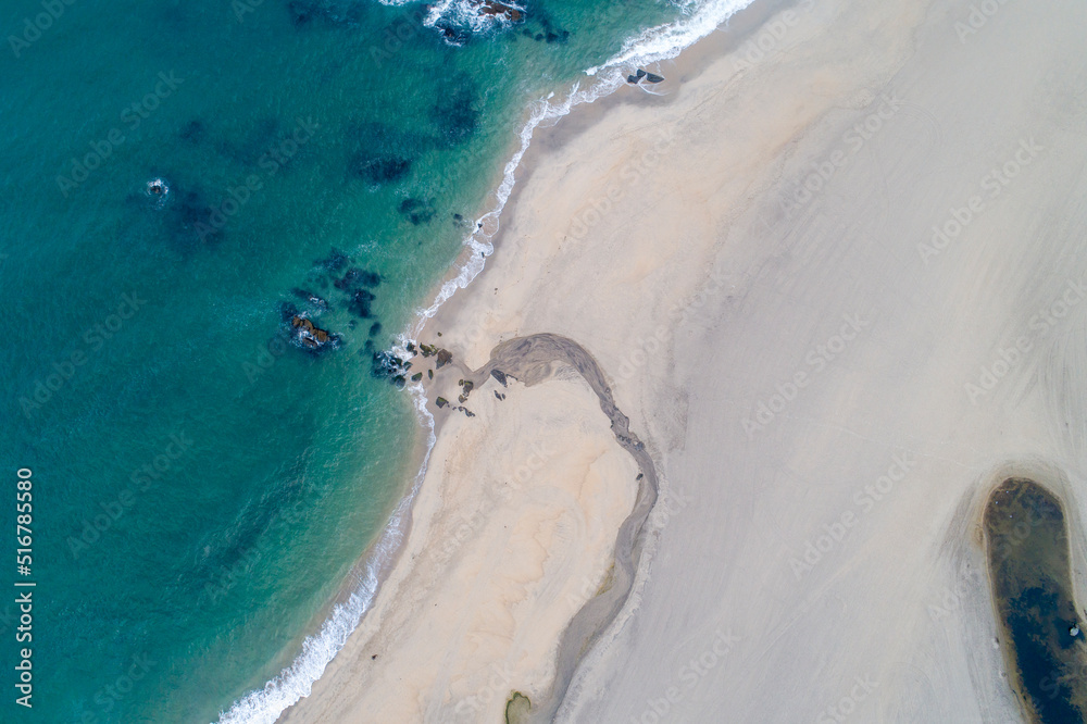Aerial view of a beach with a small stream