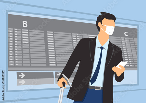 Businessman walking with luggage and using smart phone