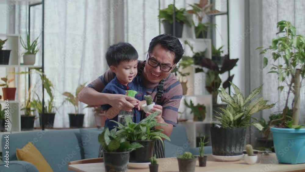 Happy Asian Man With Son Watering Plants At Home
Happy Asian Man With Son Watering Plants At Home