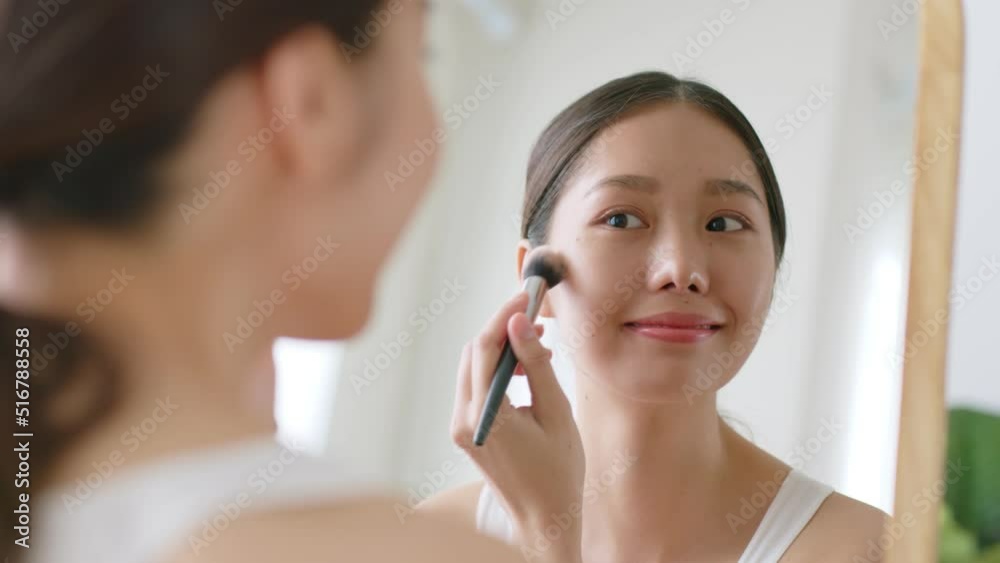 Young Asian woman apply makeup blush on beautiful natural face, makeup and cosmetic concept Young Asian woman apply makeup blush on beautiful natural face, makeup and cosmetic concept