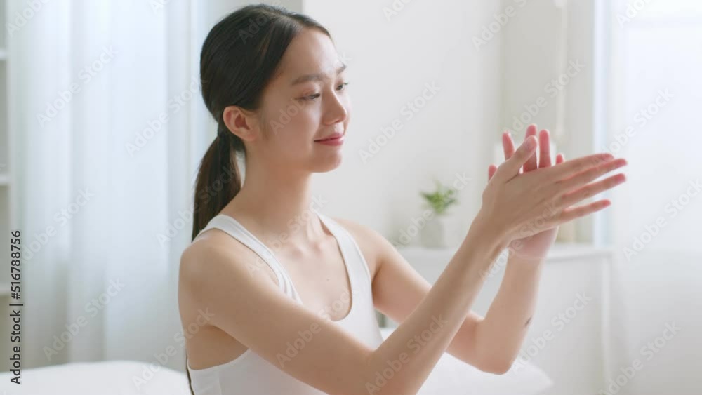 Young asian woman applying body lotion and skincare cream Young asian woman applying body lotion and skincare cream