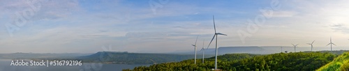 panoramic photo A view that sees a large windmill surrounded by mountains and rivers.