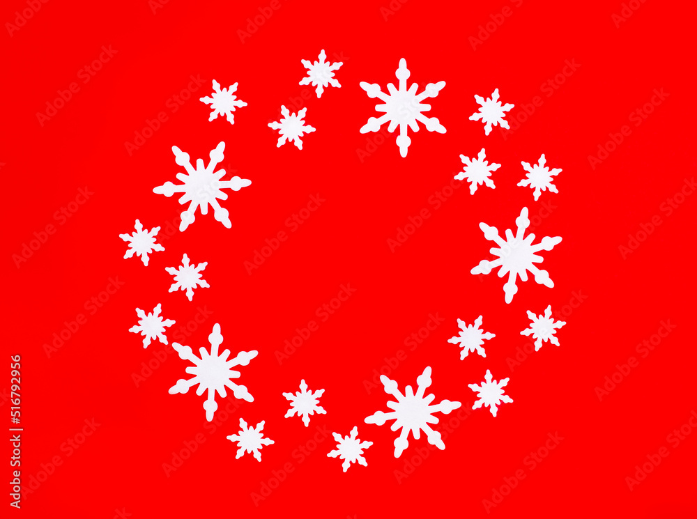 On a bright red background, white snowflakes in the shape of a circle with a place to insert text inside. Place to copy. Christmas concept On a bright red background, white snowflakes in the shape of a circle with a place to insert text inside. Place to copy. Christmas concept