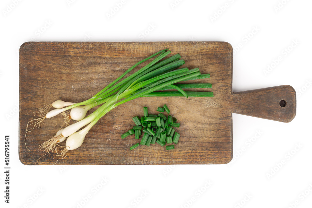 Fresh green onion on wooden board. Isolated on white background. Top view Fresh green onion on wooden board. Isolated on white background. Top view