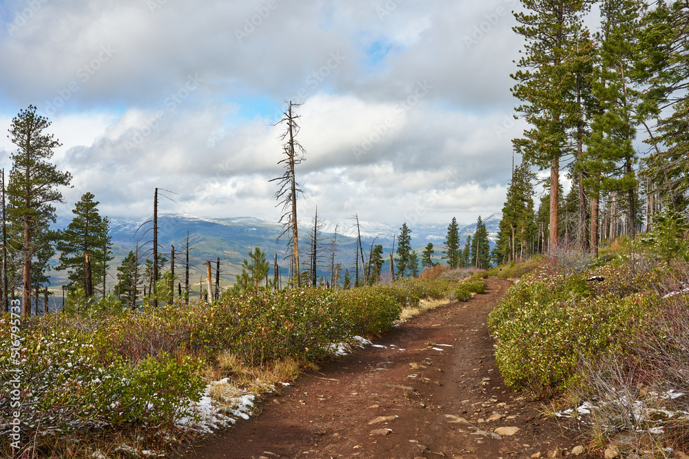 Dirt road in the mountains with clouds on the sky in central Oregon in autumn season. Dirt road in the mountains with clouds on the sky in central Oregon in autumn season.