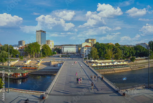 The city of Nis in Serbia during summer. Panoramic view of the city center and big pedestrian bridge on the river Nisava. photo