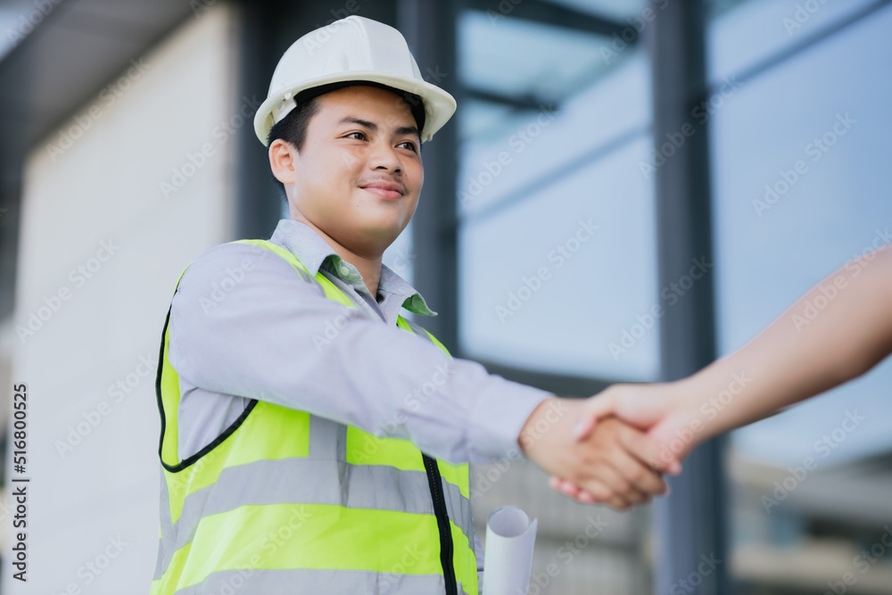 Engineer construction workers shaking hands while working teamwork and cooperation concept after finish agreement construction site, Engineering construction worker, Success collaboration concept. Engineer construction workers shaking hands while working teamwork and cooperation concept after finish agreement construction site, Engineering construction worker, Success collaboration concept.