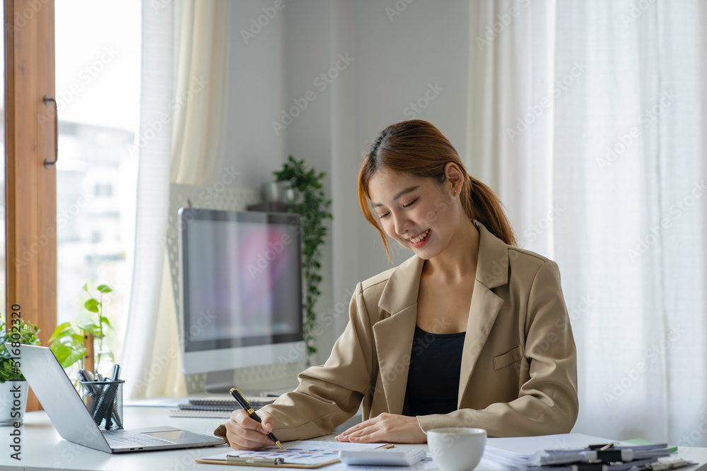 A beautiful Asian woman is working on collecting documents and information of the company's financial performance for the meeting. Account Analysis and Audit