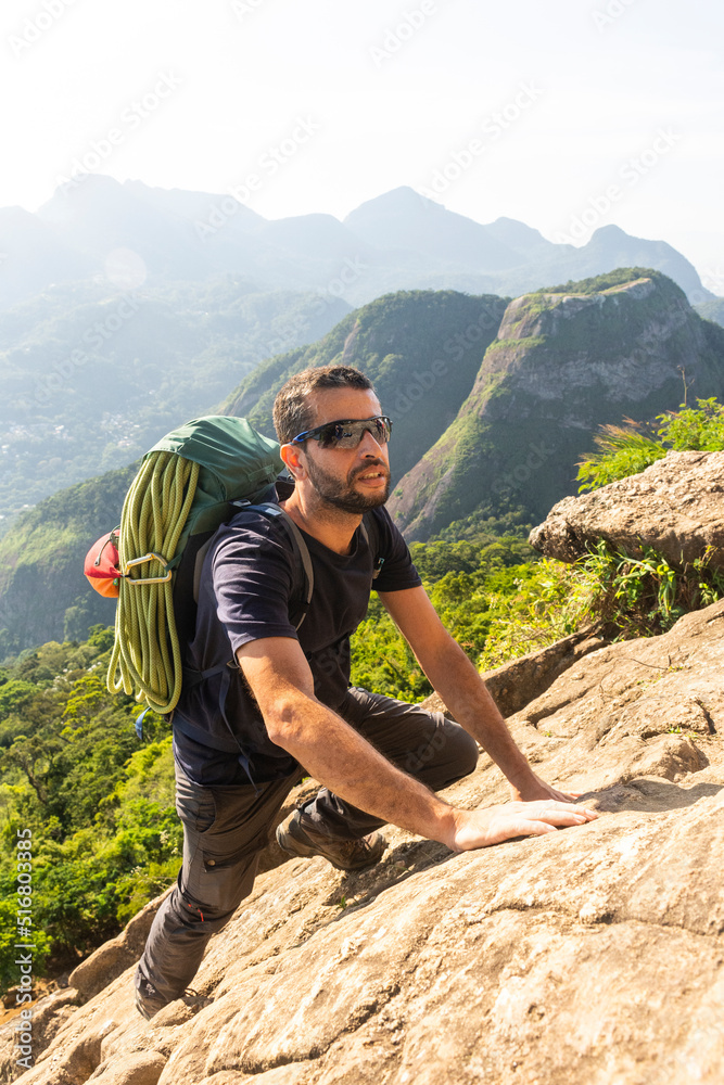 Beautiful view to man rock climbing green rainforest rocky mountain