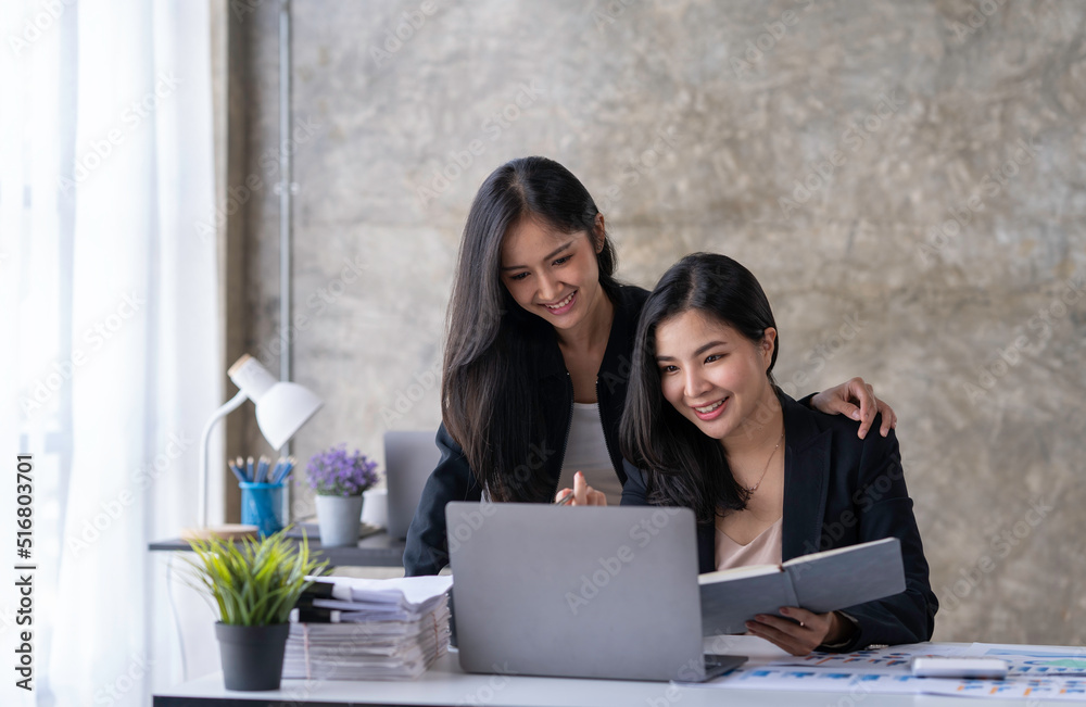 Portraits of two businesswomen consulting on their project while working in office room, Two Businesswomen Working On Computer In Office