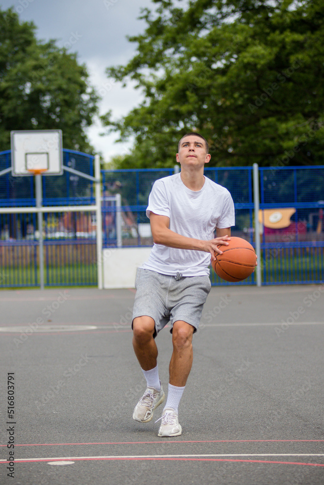 Obraz premium A Nineteen Year Old Teenage Boy Playing Basketball
