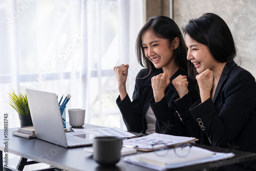 Portrait of Asian businesswoman using computer in video conferencing, presenting marketing plan using statistical data sheet at work.
