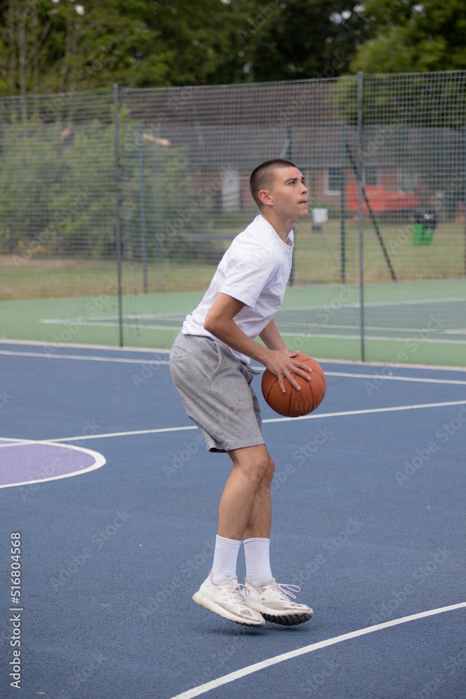 Obraz premium A Nineteen Year Old Teenage Boy Playing Basketball