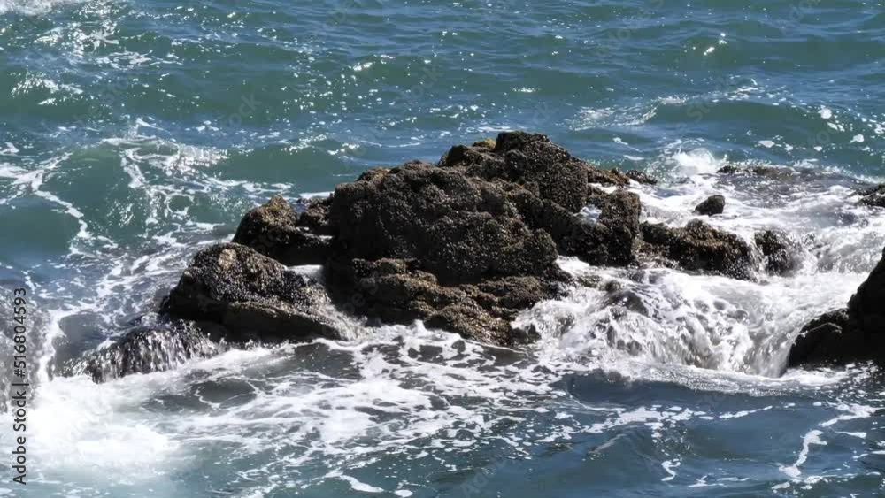 Small sea waves. Big rocks in the water. Handheld video. Small sea waves. Big rocks in the water. Handheld video.