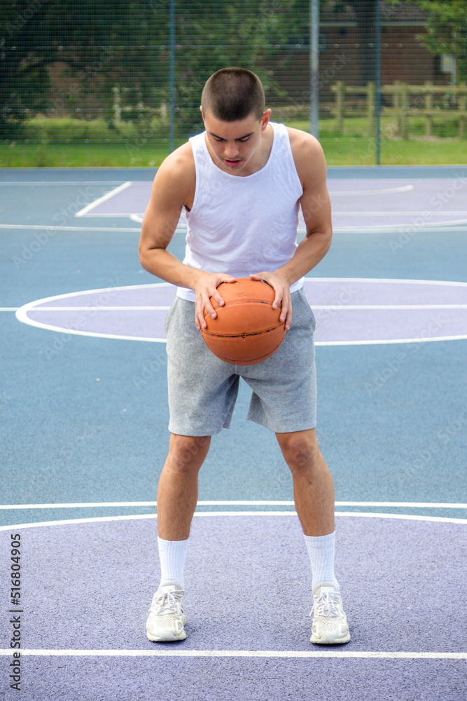Obraz premium A Nineteen Year Old Teenage Boy Playing Basketball